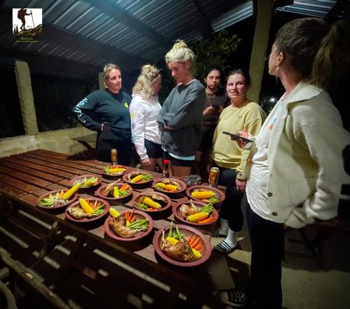 a group of people standing around a table of food at Royal Mountain Edge ,Knuckles in Rangala