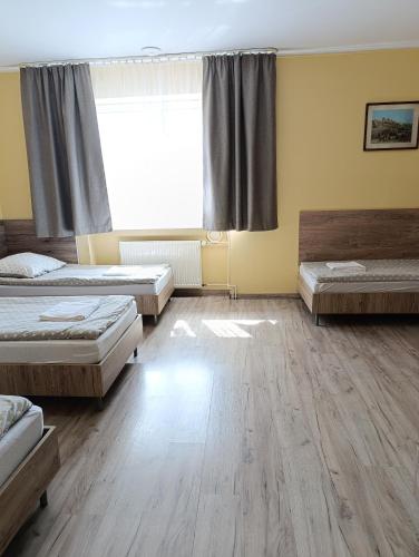 a room with two beds and a window at Noclegi "Poza Szlakiem" in Wałbrzych