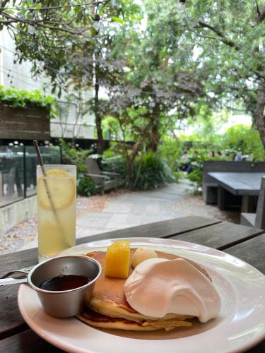 a plate of breakfast food on a table with a drink at Kamakura Jomyoji Terrace-鎌倉浄明寺テラス- in Kamakura