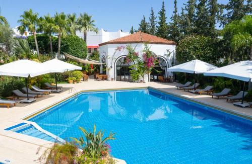 una piscina con sedie e ombrelloni in un resort di Hotel Karia Princess a Bodrum City