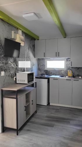 a kitchen with white cabinets and a counter top at Camping Costa Blanca in El Campello