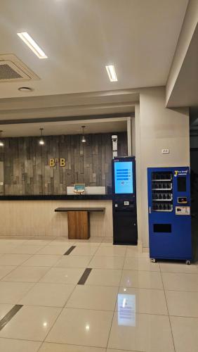 a lobby with a counter and a blue vending machine at Jeju BnB Hotel in Jeju