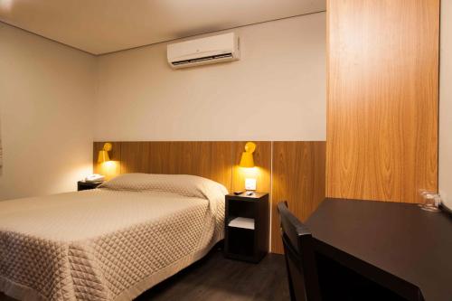 Una cama o camas en una habitación de Hotel Grand Barão