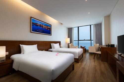 Postel nebo postele na pokoji v ubytování Grand Tourane Hotel Da Nang