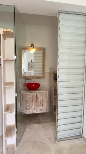 a bathroom with a red sink and a mirror at Akdeniz Villa in Kas