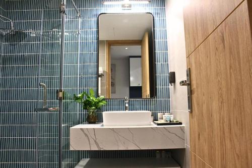 a bathroom with a sink and a mirror at Flamingo Hải Tiến Tầng 15 View Hướng Biển, Cực Chill in Thanh Hóa