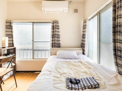 a bedroom with a bed and a large window at D Hotel - Vacation STAY 89642v in Tokyo