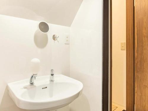 a white bathroom with a sink and a mirror at D Hotel - Vacation STAY 89642v in Tokyo