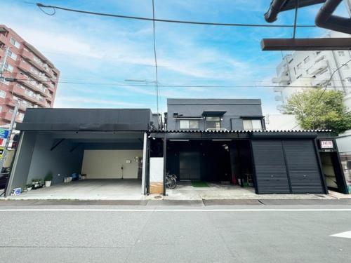 a building with a parking lot with a garage at D Hotel - Vacation STAY 89642v in Tokyo
