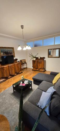 a living room with two couches and a table at HelloZagreb Apartment in Zagreb