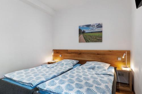 two beds in a room with a picture on the wall at Ferienwohnung Möckmühl in Möckmühl