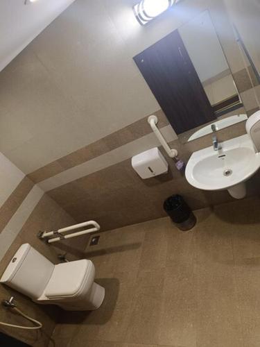 a bathroom with a toilet and a sink at Prayana Hotels in Cochin