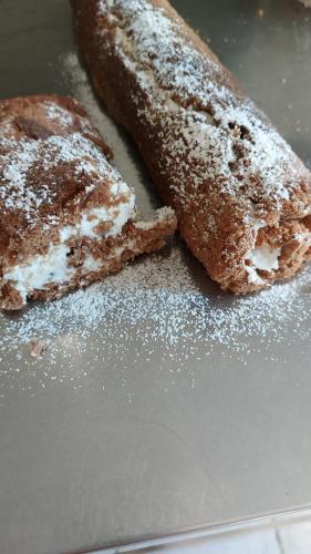 two pieces of bread with powdered sugar on a table at Agriturismo La Selva in Nocera Umbra