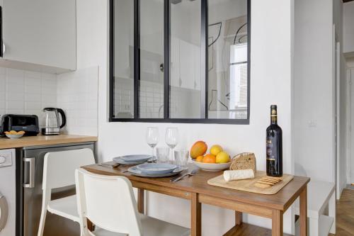 une cuisine avec une table avec une bouteille de vin dans l'établissement suite Joyful Ivy - Cozy apartment in Paris, à Paris