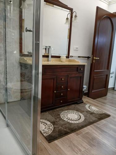 a bathroom with a shower and a sink with a mirror at Villa Fontana Saia in Paola