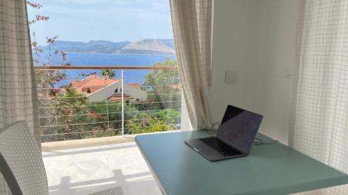 a laptop sitting on a table in front of a window at Akdeniz Villa in Kas