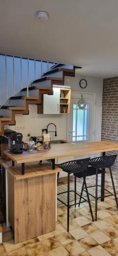 a kitchen with a wooden table and a staircase at Ferienhaus Altes Zollhaus Teutoburger Wald Ferienwohnung in Horn-Bad Meinberg