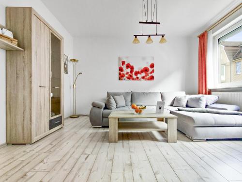 a living room with a couch and a coffee table at Haus Küstenperle in Cuxhaven