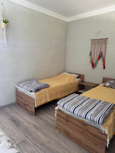 two beds in a room with two beds sidx sidx sidx at Квартиры под соснами in Cholpon-Ata