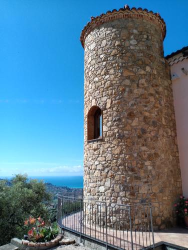 a tower of a stone building with a window at Casa dell'Ulivo da Lisa e Alessio008062-LT-0023 in Vallebona