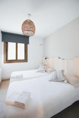 Postel nebo postele na pokoji v ubytování Apartaments i Bungalows Càmping L'Orri del Pallars