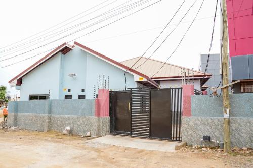 a house with a gate in front of it at The Hideaway in Accra