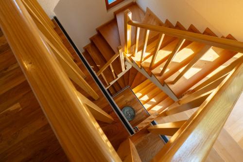 an overhead view of a wooden staircase in a house at LivingIn Delta - Casa de Vacanta in Crisan