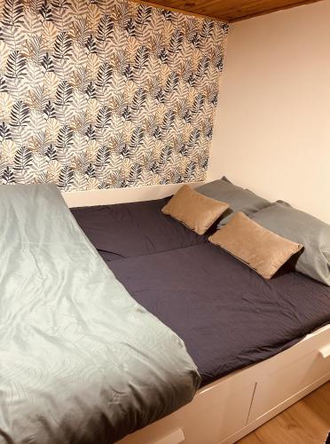 a bed with two pillows on it in a bedroom at Chalet des faisans in Hastière-par-delà