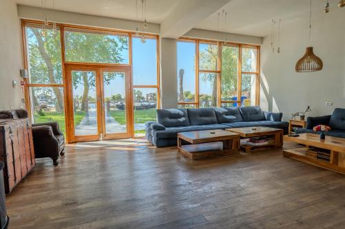 a living room with a blue couch and a table at LivingIn Delta - Casa de Vacanta in Crisan
