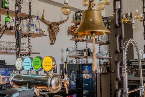 a ringing bell in a bar with bottles and glasses at LivingIn Delta - Casa de Vacanta in Crisan