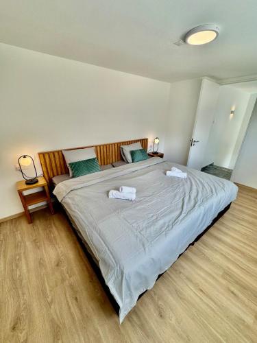 a bedroom with a large bed with two towels on it at Luxury Maisonette with Terrace in Paphos