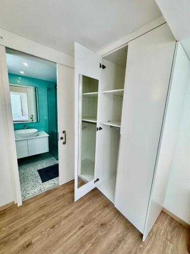 a room with white closets and a bathroom at Luxury Maisonette with Terrace in Paphos