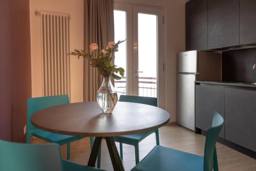 a vase of flowers on a table in a kitchen at Residence Solei Classic & Plus in Brenzone sul Garda