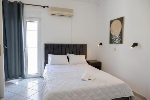 a bedroom with a bed with two towels on it at Aethra Villa in Sounio