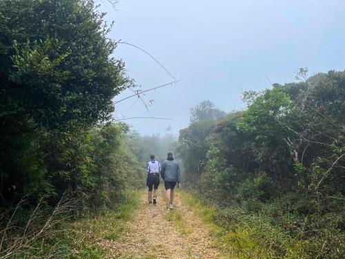 two people walking down a dirt road at Royal Mountain Edge ,Knuckles in Rangala