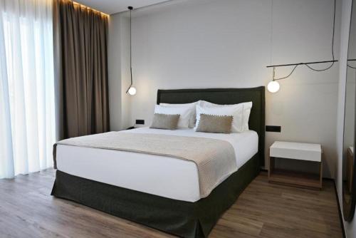 Postel nebo postele na pokoji v ubytování Muze Hotel