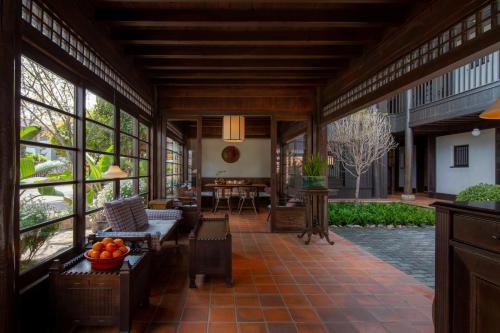 a living room with large windows and a table at Lijiang Old Town Lanshe hotel in Lijiang