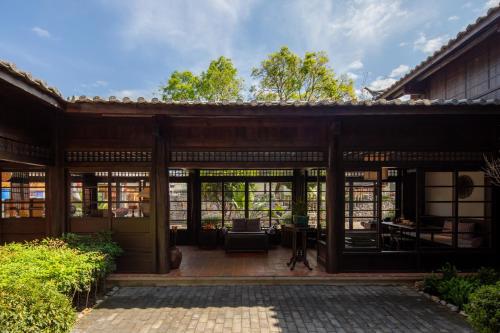 an external view of a house with glass doors at Lijiang Old Town Lanshe hotel in Lijiang