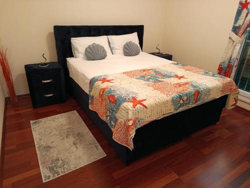 a bedroom with a bed with a quilt on it at Golden Panorama in Novalja
