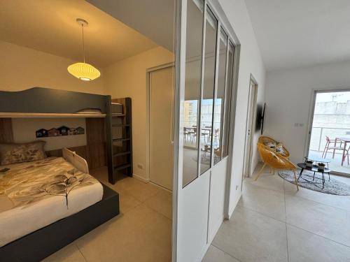 - une chambre avec un lit et une chambre avec une table dans l'établissement Appartement 225, CORAL à la plage de la Conque, au Cap d'Agde