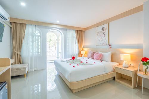 a bedroom with a large bed with roses on it at Seaside Patong House - Newly Open in Patong Beach