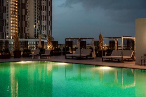 a pool on the roof of a building at night at Dusit Princess Melaka in Melaka