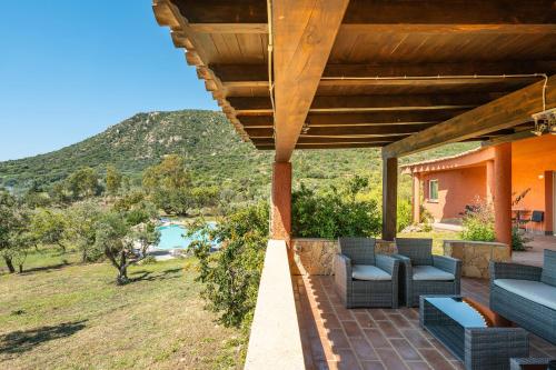 a patio with chairs and a view of a mountain at Harmònia Residence in Villasimius