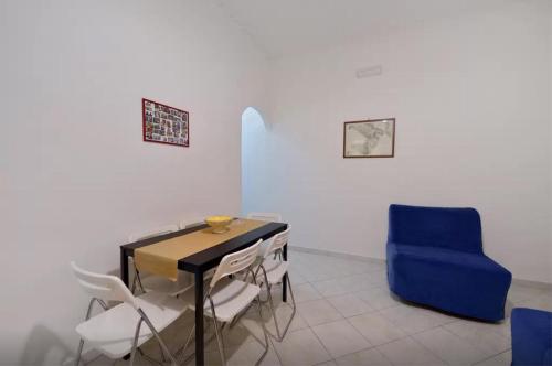 comedor con mesa y silla azul en Trimarchi House, en Nápoles
