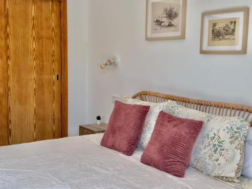 a bedroom with a bed with three pillows on it at Can Vilàs in Muro