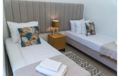 a room with two beds and a table with a lamp at Intempo Apartment 2F by VivaMar in Benidorm