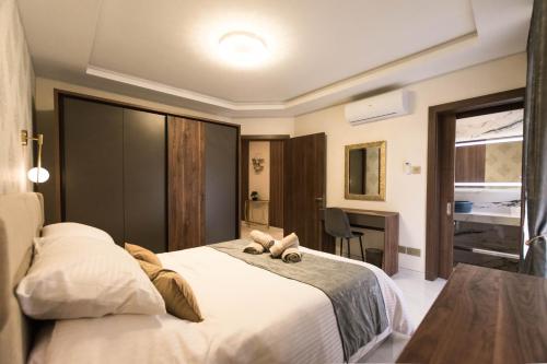 a bedroom with a bed with a teddy bear on it at Luxury Seaside Eastlynn Flat Ghadira, Mellieha in Mellieħa
