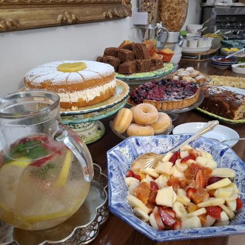 a table with many different types of cakes and desserts at Hotel Villa Verde in Ischia