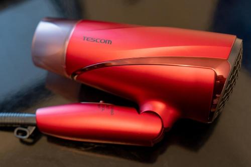a red blow dryer sitting on top of a table at Abe101 in Sapporo
