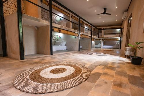 a large room with a large rug on the floor at Penida Patio Hostel in Toyapakeh